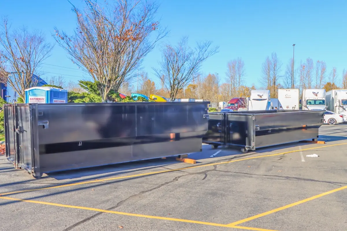 Professional dumpster rental service with roll-off container on residential driveway in Venersborg